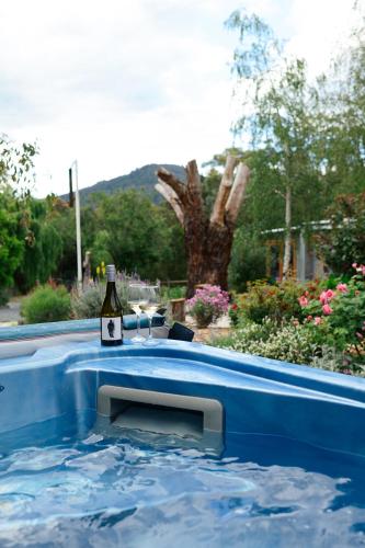 a bottle of wine sitting in a hot tub at Tuscan Farmhouse in Launching Place