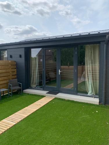 an extension of a house with sliding glass doors at Farmhouse Bintje met Airco in Westdorpe