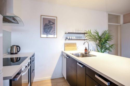 a kitchen with a sink and a counter at Frederiksberg stunning apartment in Copenhagen