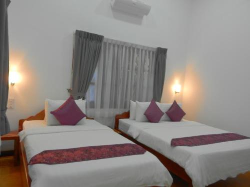 A bed or beds in a room at Eureka Villas Siem Reap
