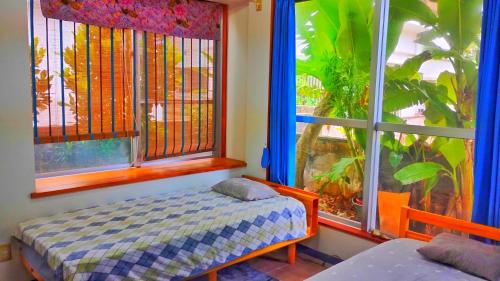 Ένα ή περισσότερα κρεβάτια σε δωμάτιο στο リリコイハウス真栄里