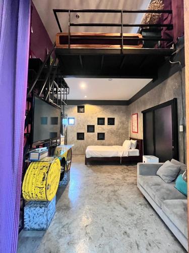 a large room with two beds and a couch at Villa Thapae in Chiang Mai