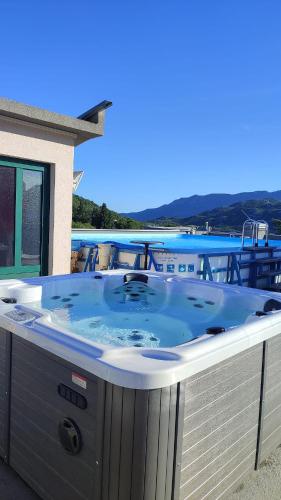 a hot tub on the deck of a house at Hotel Prvan in Vrgorac