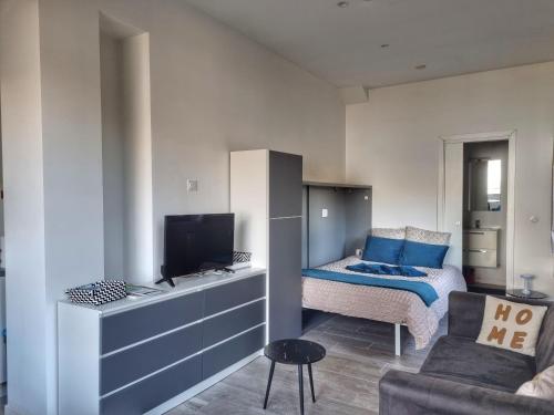 a small bedroom with a bed and a television at Appartement Cozy 2 Panoramique Lac Léman Thonon-Les-Bains in Thonon-les-Bains