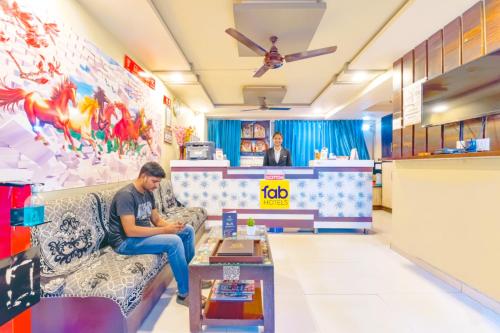 a man sitting on a couch in a store at Via Apollo - Nr Odhav Ring Road in Naroda