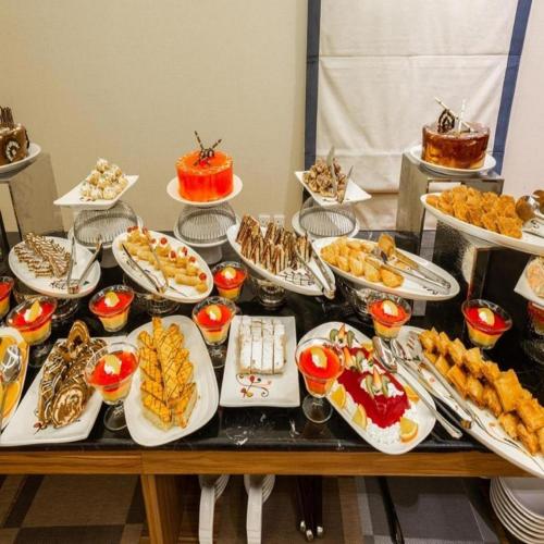 een buffet met veel gerechten op tafel bij Sunday Luxury Central formerly Anan hotel in Riyad