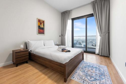 a bedroom with a bed and a large window at Free housekeeping visits during your stay - StayShort - Jebel Ali Sleeps 2 with a Beautiful Swimming Pool in Dubai