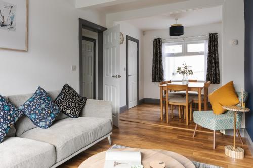 a living room with a couch and a table at Luxurious 3 Bedroom Home in Belfasts Trendy Lisburn Road Sleeps 6 Modern & Spacious in Belfast