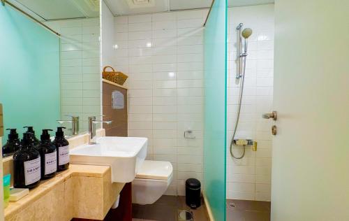 a bathroom with a sink and a toilet and a shower at Modern studio with Beach and Pool in Al Marjan Island in Ras al Khaimah