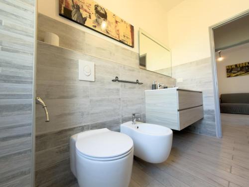 a bathroom with a white toilet and a sink at Quiet Home in Val Brona in Valbrona