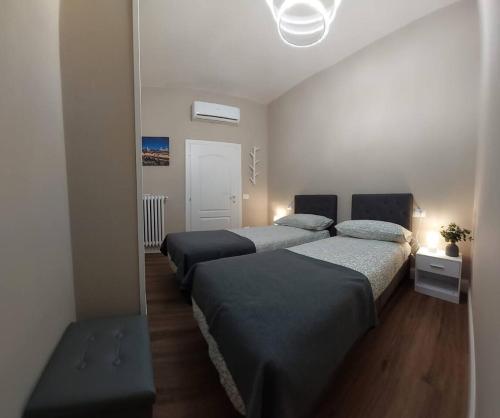 a bedroom with two beds and a mirror at Perla Toscana - Relax a 30 km da Firenze in Podere Modello