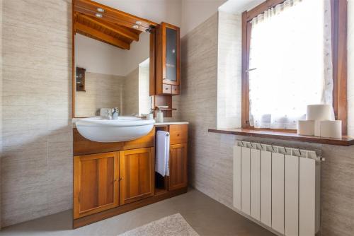 a bathroom with a sink and a window at IseoLakeRental - Chalet Giulia in Sovere
