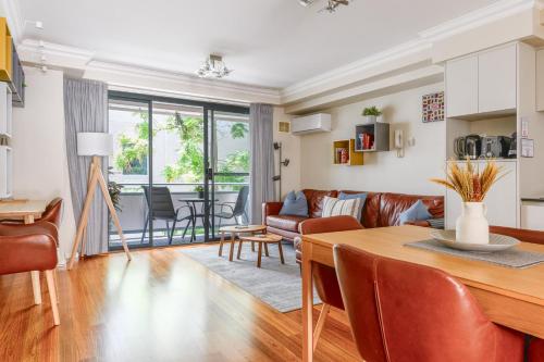 a kitchen and living room with a table and chairs at 2 Royal Rest Quality 2BR West Perth-parking in Perth