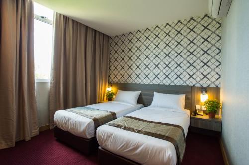 Postel nebo postele na pokoji v ubytování LS Hotel