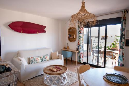 a living room with a couch and a table at Alma Ventura House - Majanicho in Majanicho