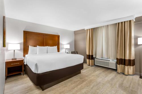 a hotel room with a large bed and a window at Comfort Inn Nashville West in Nashville