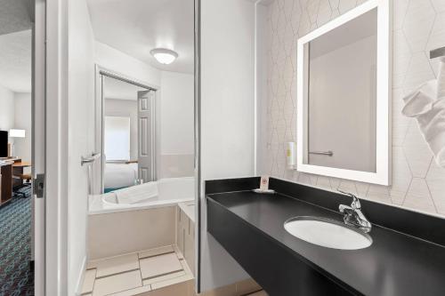 a bathroom with a sink and a mirror at Comfort Inn & Suites Berea in Berea
