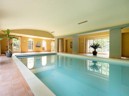 a swimming pool in a house with a pool at Beautiful Villa in Drunen with Private Heated Pool in Drunen