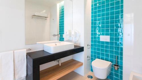 a bathroom with a sink and a toilet at Alfagar Prestige in Albufeira