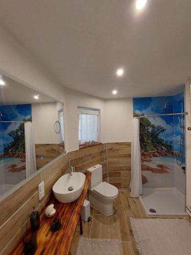 a bathroom with a sink and a toilet and a tub at Nussperle in NuÃŸbaum