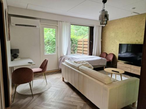 a living room with a couch and a bed at Golden apartment- parking, wifi and sauna in Raisio