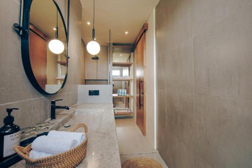 a bathroom with a sink and a mirror at Villa Grazia Luxury Retreat Canggu in Canggu
