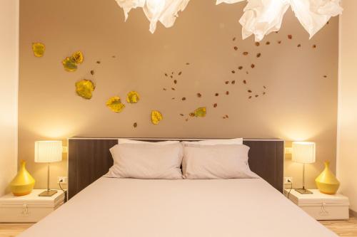 a bedroom with a bed with yellow crystals on the wall at Casa Stucky in Udine