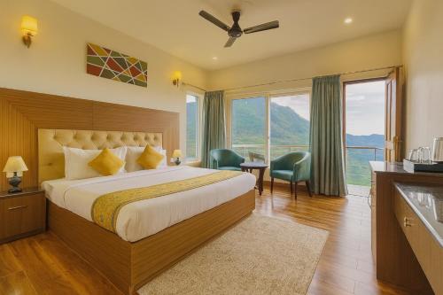 a bedroom with a bed and a large window at The Kempty Osasis - A Boutique Resort With Scenic Mountain View in Mussoorie in Mussoorie