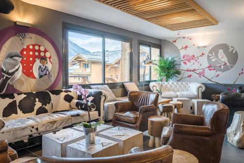 a living room with couches and chairs and a table at Anova Hotel & Spa in Montgenèvre