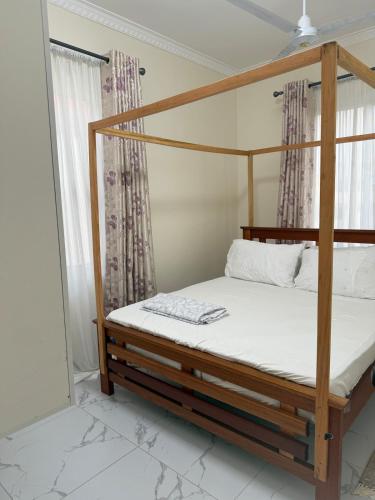 a bedroom with a bunk bed in a room at Waridi is a modern, cosy penthouse in Mtwapa town in Mtwapa