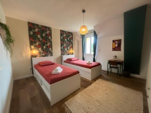 a bedroom with two beds and a window at Le Rétro Club Discothèque in Champlay