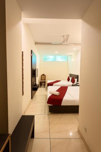 a bedroom with a bed and a television in it at Hotel JB Regency & Banquet Hall ll Family Hotel ll Top Rated Property in Chandīgarh