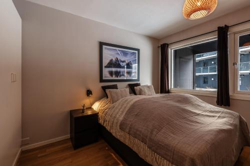 a bedroom with a bed and a window at Geilo Town Centre - Apartment with a Superb Location and walking Distance to Everything in Geilo