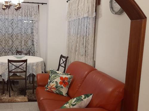 a living room with a leather couch and a table at Amarante Residence in Amarante