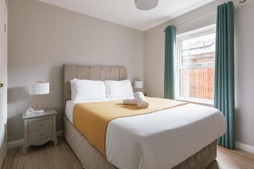 a bedroom with a large bed and a window at Luxurious 2 Bedroom City Centre Apartment Walking Distance to Everything Sleeps 6 in Belfast