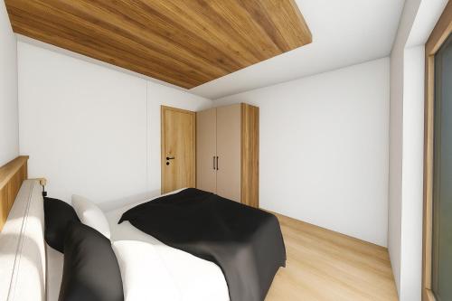 a bedroom with a bed and a wooden ceiling at PUREALPS Apartment - Opening December 2025 in Schwendberg