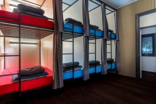 a room with four bunk beds in it at Capsule Hostel Perth - note - Valid passport required to check-in in Perth