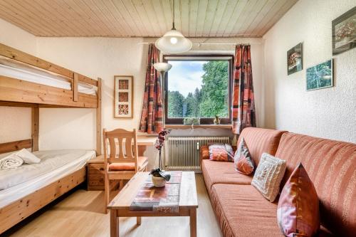 a living room with a couch and a bed and a window at Panorama Ferienwohnung Tschengla in Bürserberg