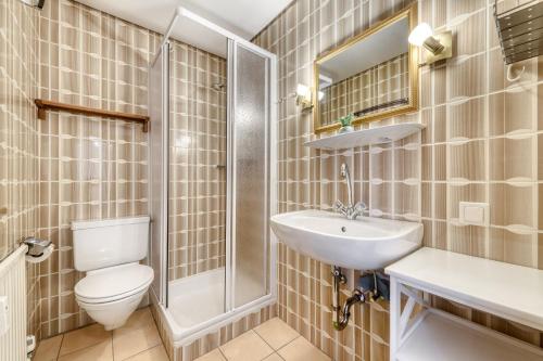 a bathroom with a toilet and a sink and a shower at Panorama Ferienwohnung Tschengla in Bürserberg