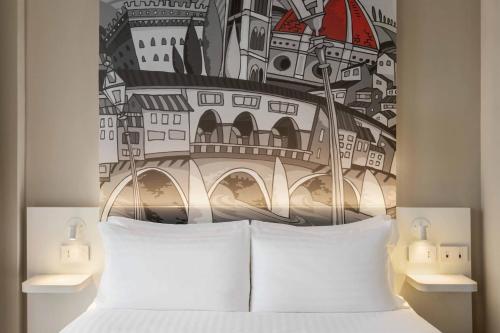 Ένα ή περισσότερα κρεβάτια σε δωμάτιο στο Hotiday Firenze Peretola