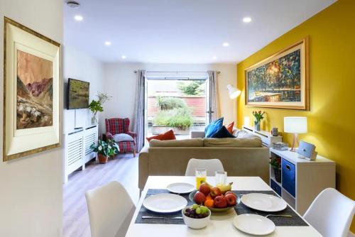 a living room with a table with fruit on it at Luxury City Apartment Underground Parking 5* in Belfast
