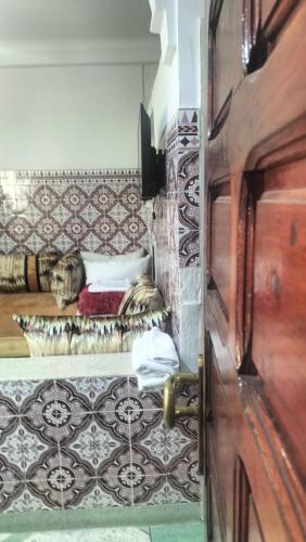 a room with a bed with a dog sleeping on it at appartement bab boujloud in Fez