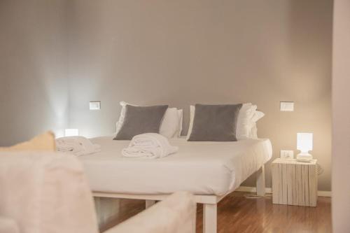 a white bed with towels on it in a room at Spacious Loft in Rome Jewish Ghetto in Rome