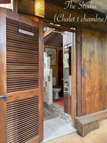 an open door to a bathroom with a toilet at My Mountain Home - Le Studio in Taravao