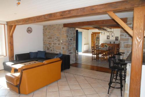 a living room with a couch and a table at Gîte du Lieu Piquot in Gréville-Hague