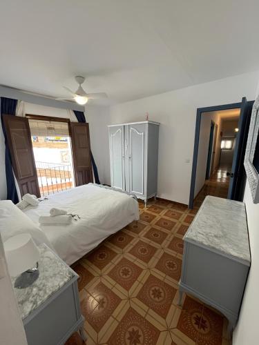 a bedroom with a large bed and two tables at La Casa Colores in Casares