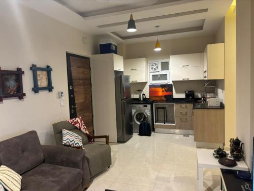 a living room with a couch and a kitchen at Quiet HOME in Hurghada