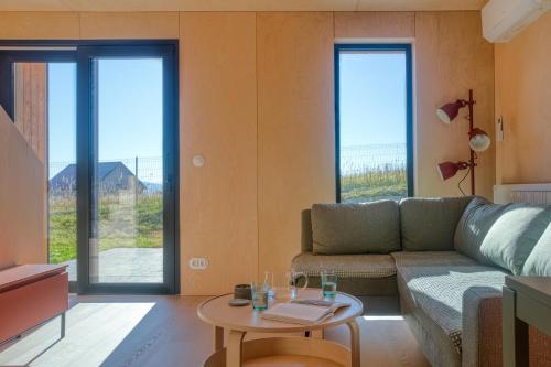 a living room with a couch and a table at Brzozowy Rożnów in Rożnów