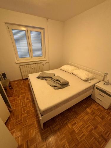 a bedroom with a bed with two towels on it at Apartma Roberto - Ankaran in Ankaran