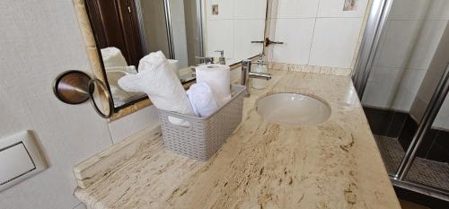 a bathroom with a counter with a sink and towels at Casa Rural Los Gaspares in La Carlota